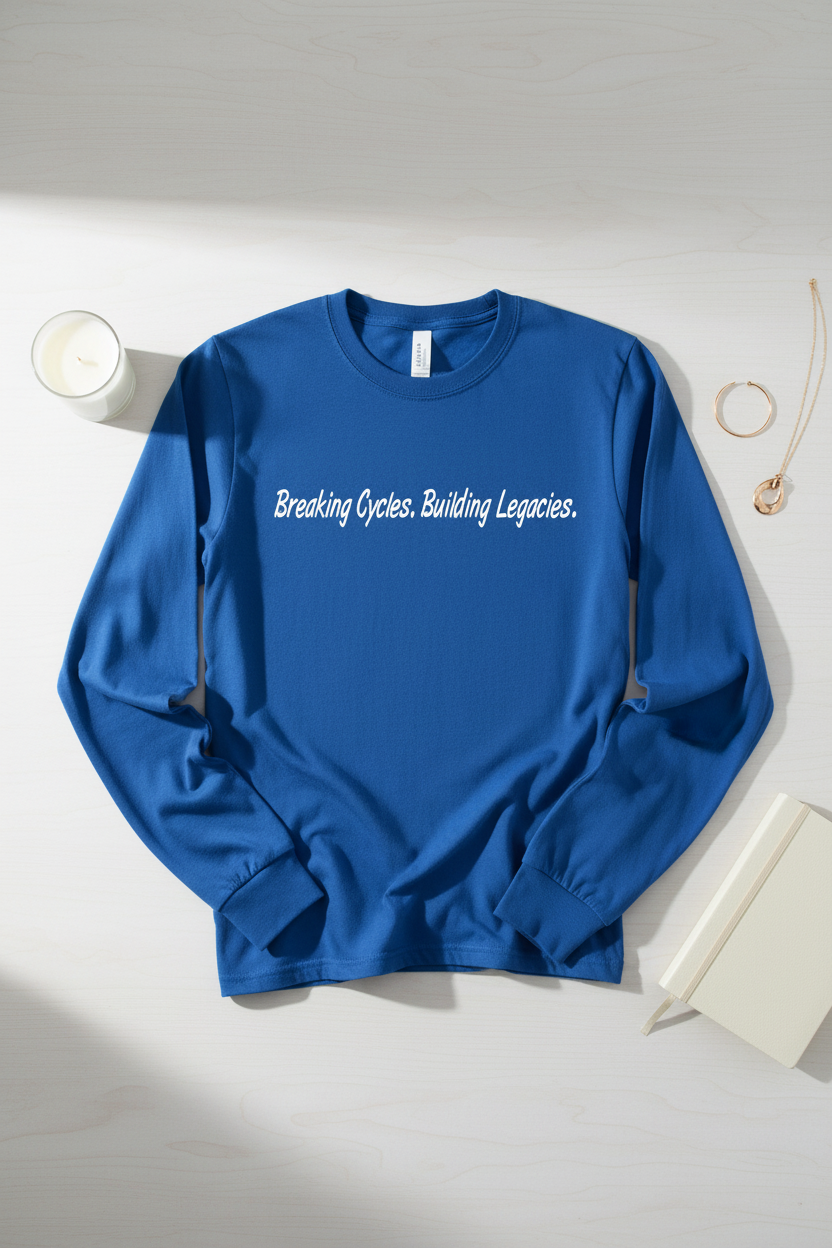 Breaking Cycles. Building Legacies. — True Royal long-sleeve tee lifestyle flat lay